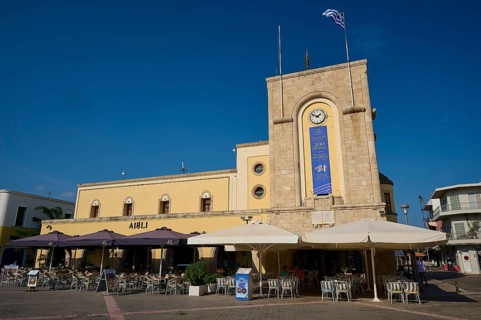 Cinema, Eleftherias Square, building with clock tower and terrace café under a clear sky, Kos Town,