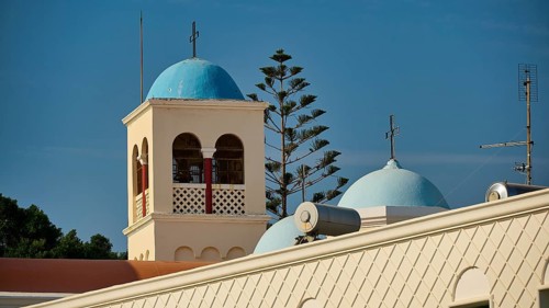 Church, Panagia Agia Paraskevi, building with blue bell tower and dome, surrounded by antennas, Kos