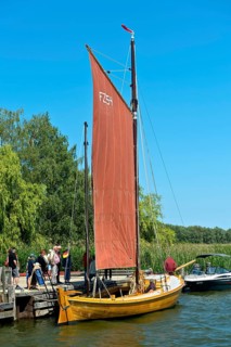 Tourists looking at a Zeesen boat at the jetty, Krummin, Usedom Island, Mecklenburg-Western