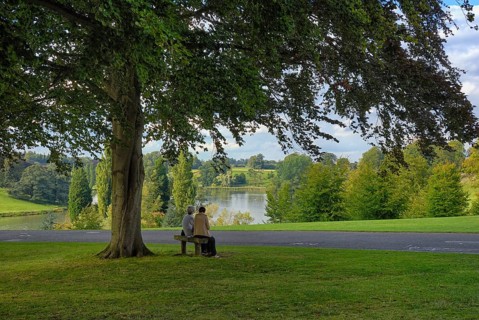 Two woman on a bench in the park of Blenheim Palace, the largest non-royal aristocratic residence