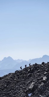 Hikers against the light on a ridge, Stubai Alps, South Tyrol, Italy