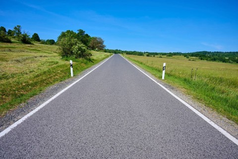 Straight country road runs through open landscape with blue sky, summer, Franzosenweg, Lange Rhön,