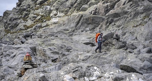Mountaineer between rocks, Wiener Höhenweg, Schober group, Hohe Tauern National Park, Carinthia,