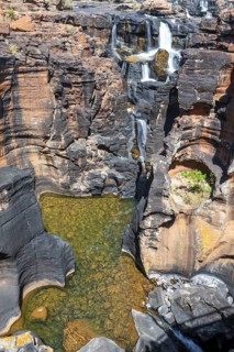 Waterfall on orange-coloured rock cliffs, long exposure, Blyde River, Bourke's Luck Potholes,