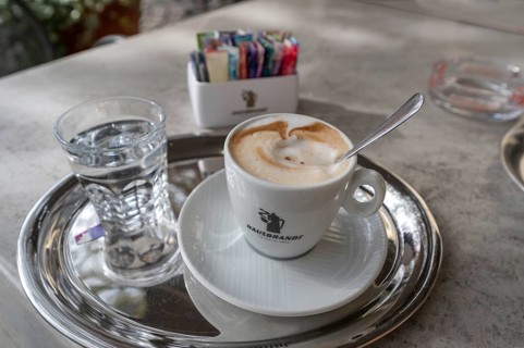 Cappuccino served with a glass of water, Bressanone, Italy