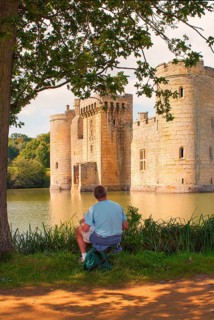 Man draws Bodiam Castle, located in East Sussex near the River Rother. It has long been one of