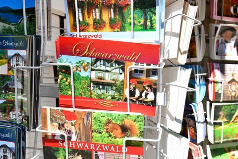 Forbach, Germany - July 12th 2025: Postcards of the German Black Forest displayed on a card stand