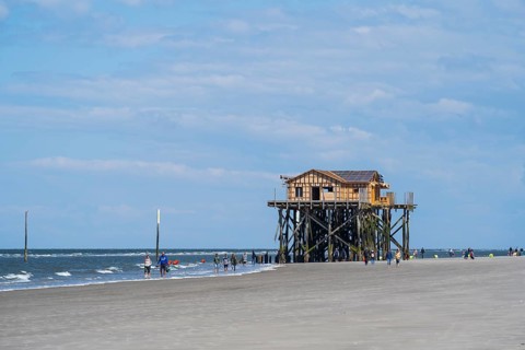 Pile dwelling and people on the beach, low tide, cloudy, Sankt Peter Ording, Eiderstedt, North