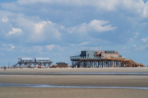 Pile dwellings on the beach, low tide, cloudy, Sankt Peter Ording, Eiderstedt, North Frisia, North