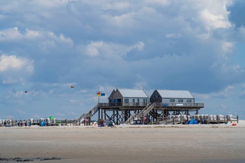 New pile dwellings on the beach with lifeguards and toilets, cloudy, Sankt Peter Ording,