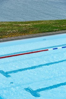 View from above of swimming pool by the sea, lane divider, lane rope in outdoor pool, Hofsos,
