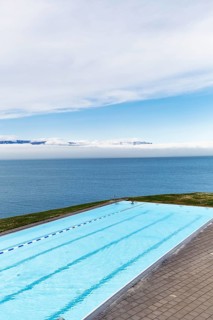 View from above of infinity pool by the sea, thermal bath, heated outdoor pool in Hofsos by