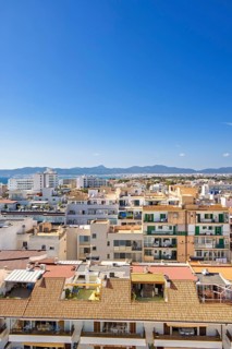 Skyline view above the house roofs in a city with tower blocks in a residental area, Can Pastilla,