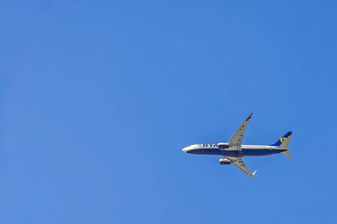 Ryanair passenger plane flying in a blue sky