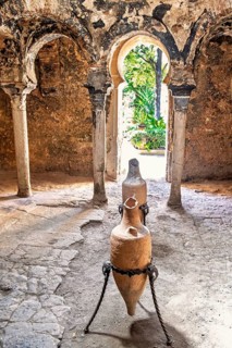 Interior at Banys Arabs Baths with old amphoras, a historic site with Islamic architecture, Palma