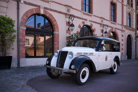Black and white Renault Juvaquatre Editorial vintage car in front of headquarters, head office,
