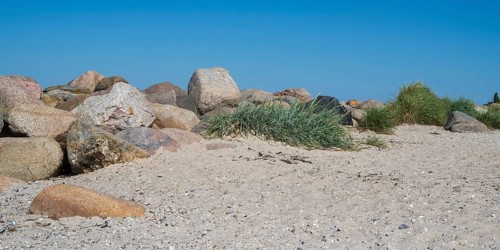 Large stones as a boundary on the sandy beach, Laboe, Baltic resort, Fjord, Baltic Sea, North