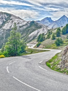 Photo with reduced dynamic saturation HDR of south ramp ascent of steep pass road with tight curves