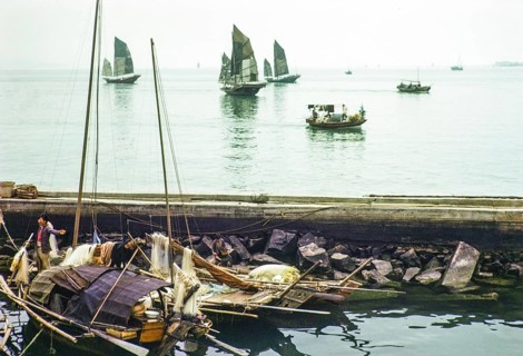 Junk ships at sea people living on sampan boats in the harbour thought to be at Causeway Bay, Hong