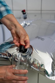 Tapping water from a 10 litre water bag, for storing drinking water at home, as an emergency