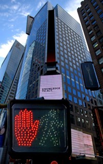 Pedestrian traffic light, skyscraper with illuminated advertising in Times Square, New York City,
