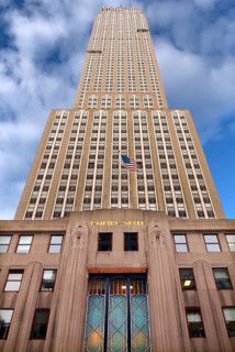 Empire State Building with US flag, New York City, USA