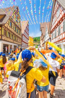 A festive group with flags in a decorated alleyway in the old town centre, 950 years of Calw, Calw