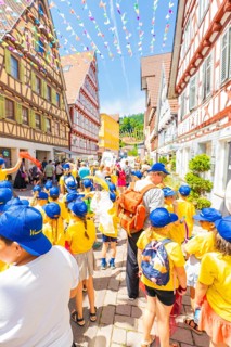 Children wear yellow clothes and blue caps at the street festival, 950 years of Calw, parade Calw,