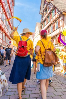 Two woman with hats in a busy, festive street, 950 years Calw, parade Calw, Black Forest, Germany