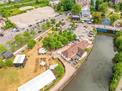 View of an event with tents and facilities along a river, 950 years of Calw, Calw parade, Black