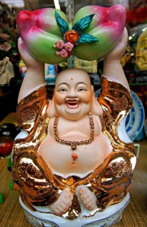 Buddah figure in a shop window, China Town, New York City, USA