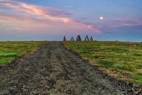 Gravel path to the Arctic Henge, large stone gates, basalt, landmark in barren landscape,