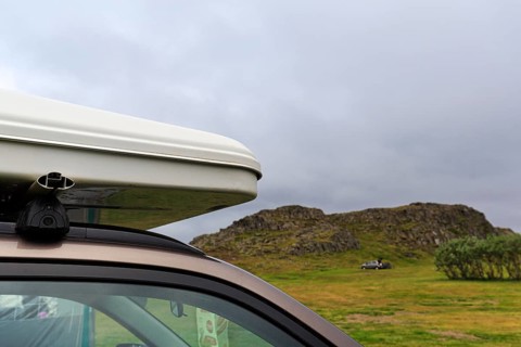 Rooftop tent on car roof in volcanic landscape, detail, camping site, rain clouds, Bakkagerdi,