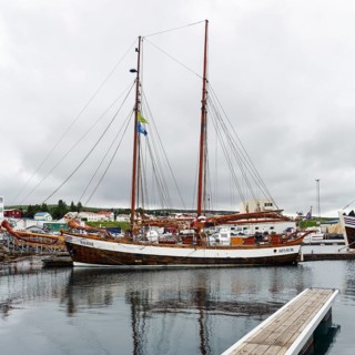 Sailing boat in the harbour, fishing village at Skjalfandi Bay, rain clouds, Husavik, Húsavík,