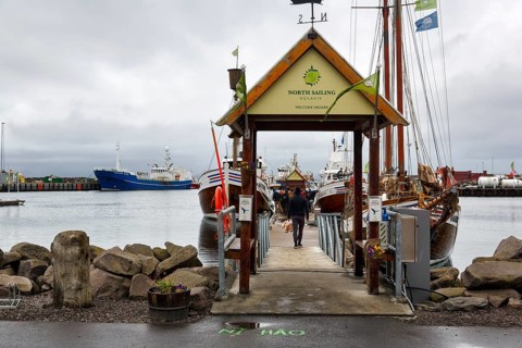 Boat dock in the harbour, fishing village at Skjalfandi Bay, rain clouds, Husavik, Húsavík, North