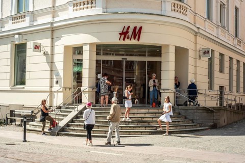 People at the entrance to the Hennes and Mauritz, H&M, department store in Ystad, Skåne County,