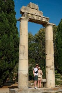 Two people posing in front of ancient columns and green trees, Ancient Agora, Kos Town, Kos,