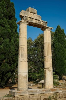 Free-standing ancient columns in front of a deep blue sky and trees, Ancient Agora, Kos Town, Kos,