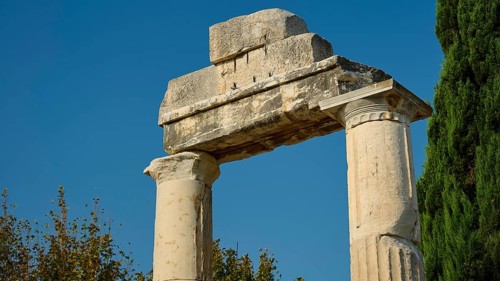 Ancient stone columns against a blue sky, surrounded by trees, Ancient Agora, Kos Town, Kos,