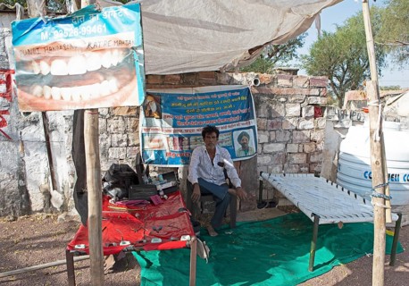 Indian man at a dentist stand in the Thar Desert or Great Indian Desert, near Jaisalmer, Rajasthan,