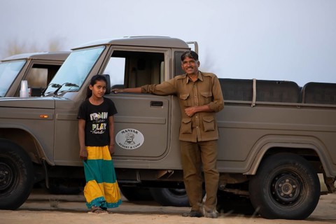 Indian man and Indian girl on a desert jeep, desert dwellers in the Thar Desert or Great Indian