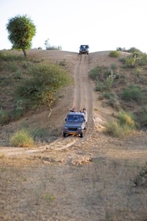 Jeeps driving down a sand dune in the Thar Desert or Great Indian Desert, near Jaisalmer,