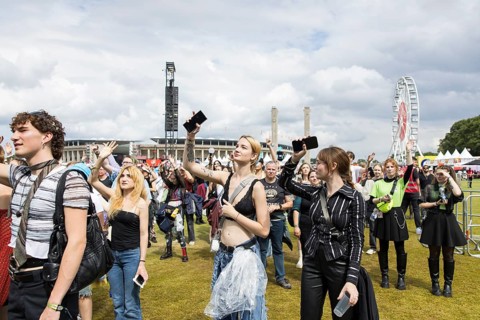 Festival visitors dance to the performance of the band Mother Mother at the Lollapalooza Festival