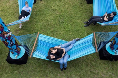 Festival visitors lying in hammocks in the Fashionpalooza at the Lollapalooza Festival in the
