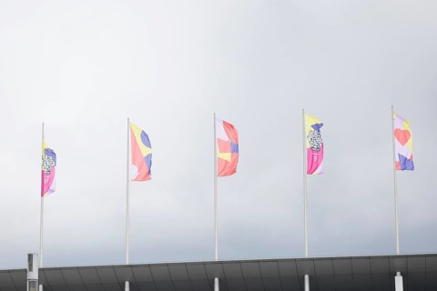 Colourful flags with the Lollapalooza logo on the roof of the Olympic Stadium at the Lollapalooza