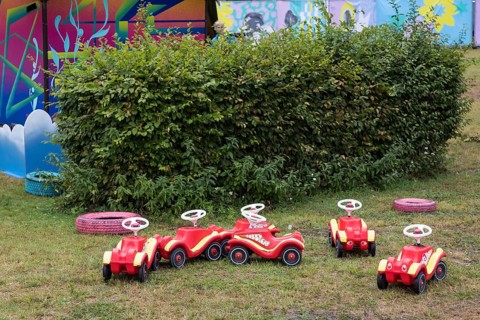Unused bobby cars are parked in a corner of the Kidzapalooza at the Lollapalooza Festival in the