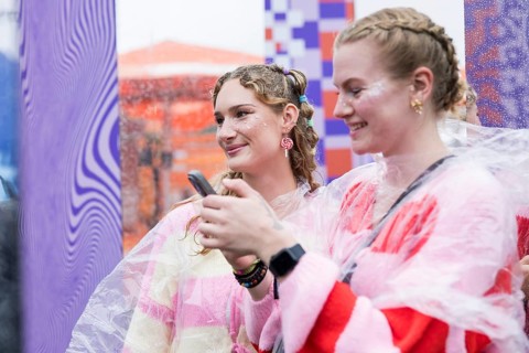 Festival visitors Emily and Celine from Halle take photos of themselves at Fashionpalooza at the