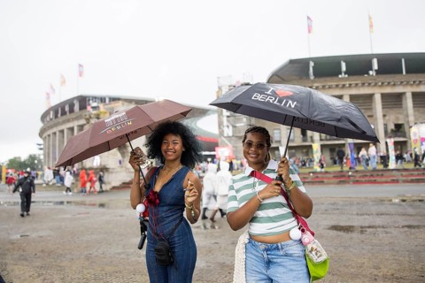 Festival visitors with Berlin umbrellas in front of the Olympic Stadium at the Lollapalooza