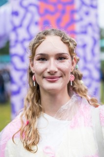 Festivalgoer Emily from Halle adorned with glitter, hearts and earrings made of candy canes at
