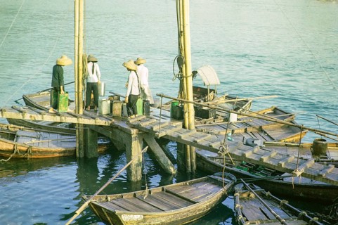 Boat dwellers with cans of water on jetty in the harbour at Aberdeen, Hong Kong, Asia 1964